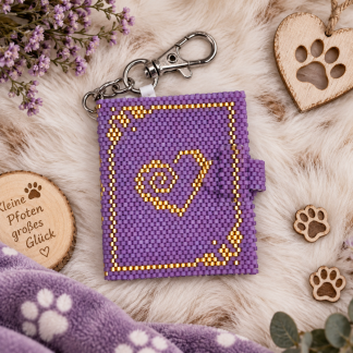 Fotobuch Pfote aus lilafarbenen Perlen mit goldenem Herzmotiv und Karabiner